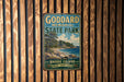 A vintage metal sign for Goddard Memorial State Park in Rhode Island, featuring a scenic landscape with a beach, trees, and a body of water.