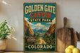A vintage-style sign for Golden Gate Canyon State Park in Colorado, featuring a scenic mountain landscape.