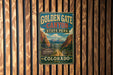 A vintage-style metal sign for Golden Gate Canyon State Park in Colorado, featuring a scenic mountain landscape.