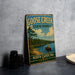 A vintage-style metal sign for Goose Creek State Park in North Carolina, featuring a scenic illustration of a lake, pine trees, and a person in a canoe.