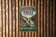 A vintage metal sign for Gooseberry Falls State Park in Minnesota, featuring a waterfall and forest scenery.