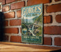 A vintage metal sign for Gorges State Park in North Carolina, featuring a scenic image of the park's natural beauty.