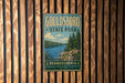 A vintage-style metal sign for Gouldsboro State Park in Pennsylvania, featuring a scenic landscape with a lake and pine trees.