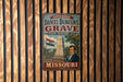 A vintage-style metal sign for the Missouri state historic site, featuring a portrait of a man and the monument.