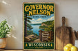 A vintage-style metal sign for Governor Nelson State Park in Wisconsin, featuring a scenic landscape with a lake and forest.
