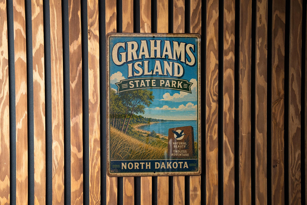 A vintage metal sign for Grahams Island State Park in North Dakota, featuring a scenic landscape with a lake and trees.