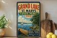 A vintage-style sign for Grand Lake State Park, featuring a scenic image of a lake, dock, and sailboat, along with the text "Grand Lake State Park, Ohio" and "Boating, Fishing, Swimming, Hiking, Memories that Last".