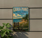 A vintage-style sign for Grass Point State Park in New York, featuring a scenic landscape with pine trees, a beach, and a rocky outcropping.