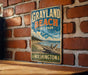 A vintage-style metal sign for Grayland Beach State Park in Washington, featuring a scenic illustration of the beach and surrounding landscape.