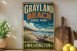 A vintage-style sign for Grayland Beach State Park in Washington, featuring a scenic landscape with a beach, mountains, and a clear blue sky.