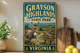 A vintage-style metal sign for Grayson Highlands State Park in Virginia, featuring a donkey and a scenic mountain landscape.