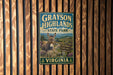 A vintage-style metal sign for Grayson Highlands State Park in Virginia, featuring an illustration of a donkey in a mountainous landscape.