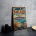 A vintage metal sign advertising the Great Salt Lake State Park in Utah, featuring a scenic illustration of the lake and mountains.