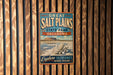 A vintage-style metal sign for Great Salt Plains State Park in Oklahoma, featuring a scenic landscape with a mountain and a large flower.
