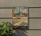 A vintage-style metal sign advertising the Great Salt Plains State Park in Oklahoma, featuring a scenic landscape with a mountain and a large flower.