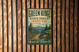 A vintage metal sign for Green Ridge State Forest in Maryland, featuring a scenic mountain landscape with pine trees and a winding trail.