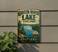 A vintage-style sign for Green River Lake State Park in Kentucky, featuring a scenic image of the lake surrounded by trees and mountains.
