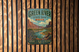 A vintage-style metal sign for Green River State Park in Utah, featuring a scenic illustration of the park's landscape.