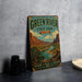 A vintage-style metal sign for Green River State Park in Utah, featuring a scenic illustration of the park's landscape.
