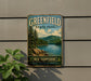 A vintage-style metal sign for Greenfield State Park in New Hampshire, featuring a scenic landscape with pine trees, a lake, and mountains.