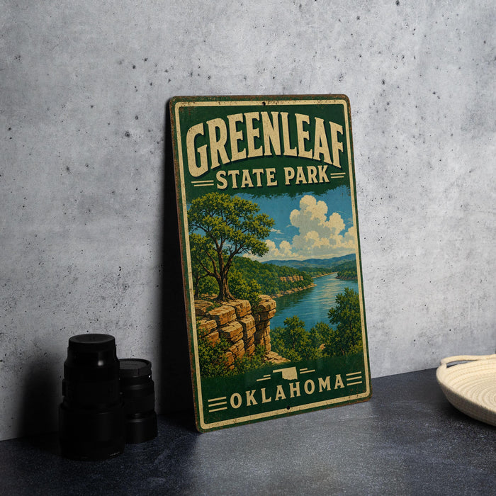 A vintage-style metal sign for Greenleaf State Park in Oklahoma, featuring a scenic landscape with a river, cliffs, and trees.