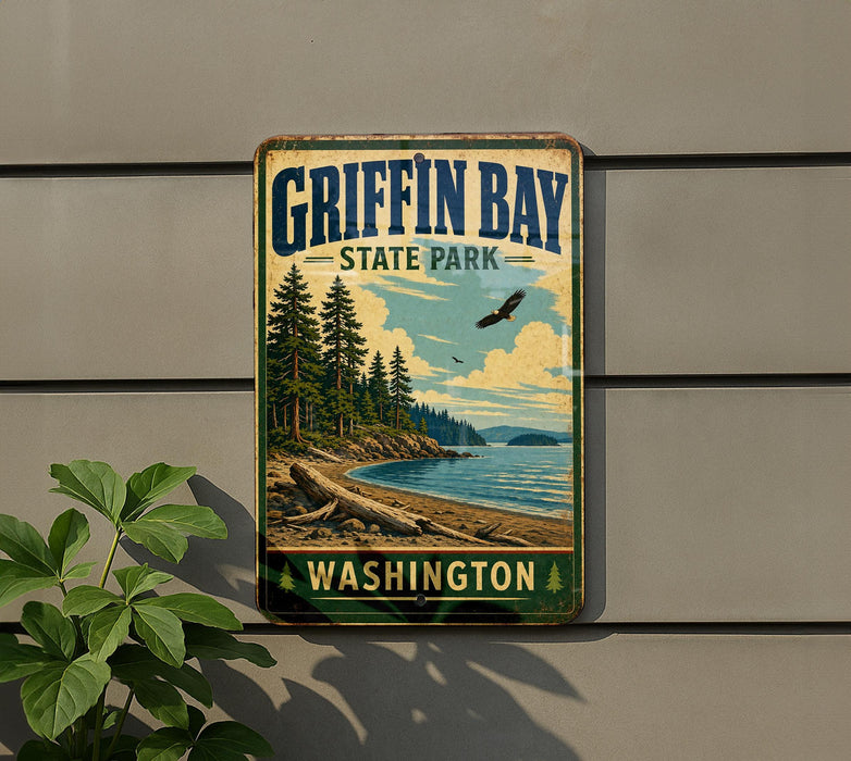 A vintage-style metal sign for the state park called "Griffin Bay" in Washington, featuring a scenic landscape with pine trees, a beach, and a bird in flight.