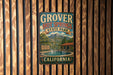 A vintage-style metal sign for Grover Hot Springs State Park in California, featuring a scenic illustration of the park's natural springs and mountains.