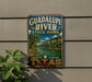 A vintage-style sign for Guadalupe River State Park in Texas, featuring a scenic landscape with a river and mountains.