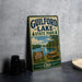 A vintage metal sign for Guilford Lake State Park in Ohio, featuring a scenic landscape with a lake, picnic table, and trees.