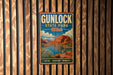 A vintage metal sign for Gunlock State Park in Utah, featuring a scenic landscape with mountains, a lake, and desert vegetation.
