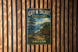 A vintage-style metal sign for Guy W. Talbot State Park in Oregon, featuring a scenic mountain landscape with a trail and a sign indicating hiking trails and beach access.