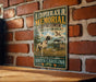 A metal sign with a vintage design hangs on a brick wall, featuring a dog and a bird in a field.
