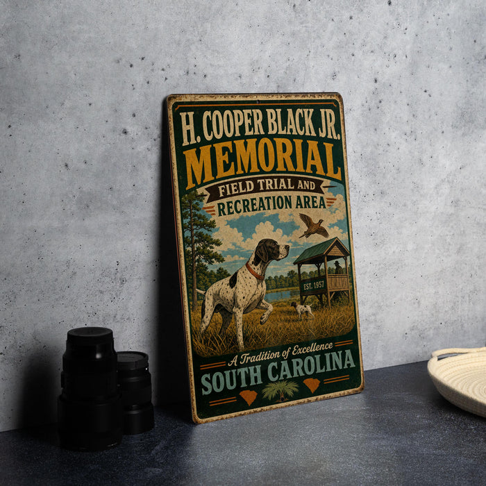 a metal sign with a vintage design, placed on a table next to some black camera lenses.