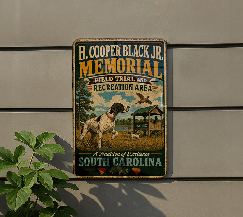 a metal sign with a vintage-style illustration of a dog in a field, with a bird in the background, mounted on a wall.
