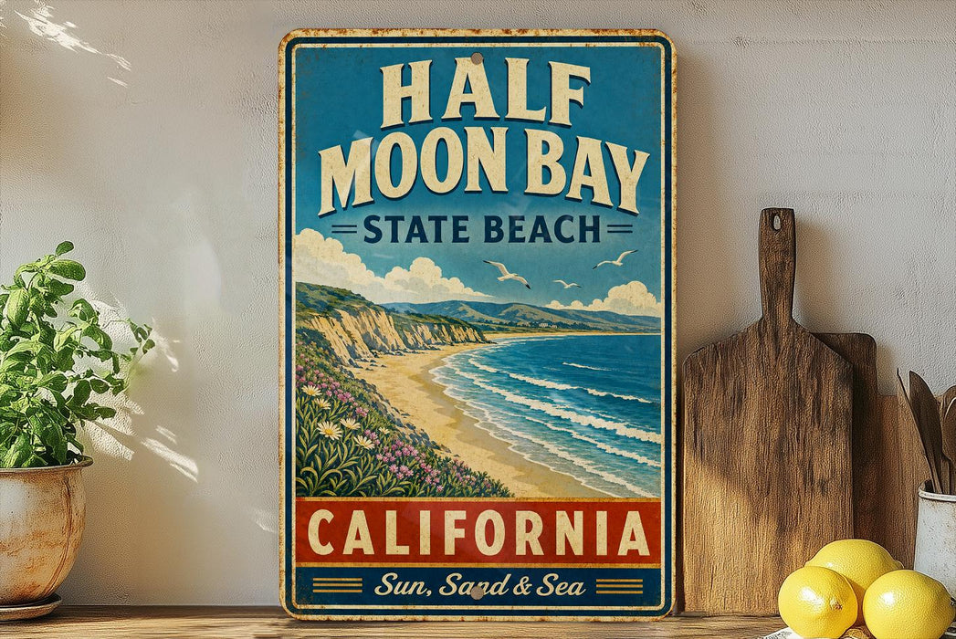 A vintage-style metal sign for Half Moon Bay State Beach in California, featuring a beach scene with mountains and a blue sky.