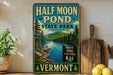 a vintage-style sign for Half Moon Pond State Park in Vermont, with a scenic landscape of a lake, mountains, and pine trees.