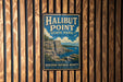A vintage metal sign for Halibut Point State Park in Massachusetts, featuring a scenic illustration of the park's cliffs and coastline.