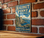 A vintage metal sign for Halibut Point State Park in Massachusetts, featuring a scenic illustration of the park's natural beauty.