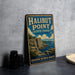 A vintage metal sign for Halibut Point State Park in Massachusetts, featuring an illustration of the park's natural landscape.