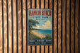 A vintage metal sign for Hamlin Beach State Park in New York, featuring a beach scene with a tree and a body of water.