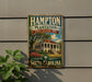 A vintage-style metal sign for Hampton Plantation, a historic site in South Carolina, featuring a building with a palm tree and a blue sky.
