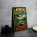 A vintage metal sign for Harmonie State Park in Indiana, featuring a scenic landscape with a river, trees, and a rocky outcrop.