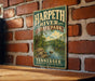 A vintage-style metal sign for Harpeth River State Park in Tennessee, featuring a scenic illustration of the river and surrounding landscape.