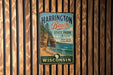 A vintage metal sign for Harrington Beach State Park in Wisconsin, featuring a scenic image of the beach and cliffs.