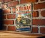 A vintage metal sign featuring a portrait of a man with the text "HARRY S. TRUMAN BIRTHPLACE" and "MISSOURI INDEPENDENCE, MISSOURI" on it, mounted on a brick wall.