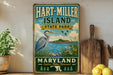 A vintage-style sign for Hart-Miller Island State Park in Maryland, featuring a blue heron and a scenic landscape.