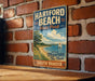 A vintage-style metal sign for Hartford Beach State Park in South Dakota, featuring a scenic illustration of a beach and a sailboat.