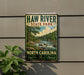A vintage-style metal sign for Haw River State Park in North Carolina, featuring a scenic landscape with a river, trees, and a bridge.