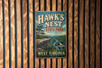 A vintage metal sign for Hawk's Nest State Park in West Virginia, featuring a scenic landscape with a cliff and a river.