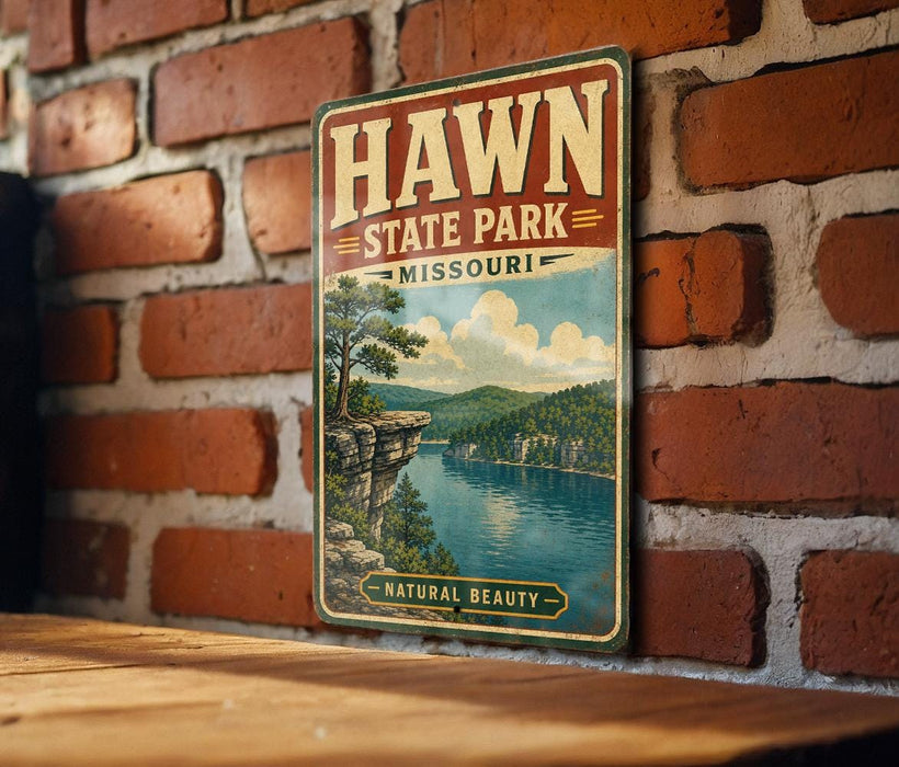 A vintage-style metal sign for Hawn State Park in Missouri, featuring a scenic landscape with a lake and mountains.